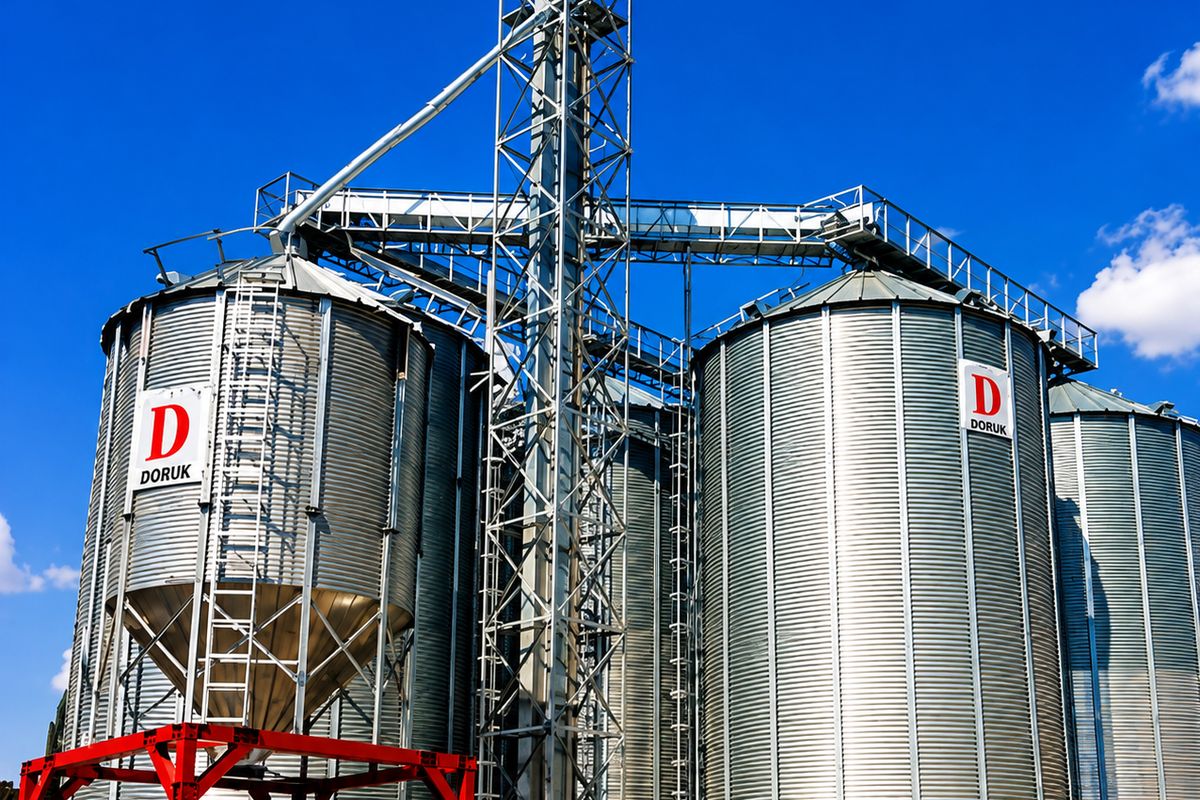 Hopper-bottom buffer silos — Elevator tower and support structure